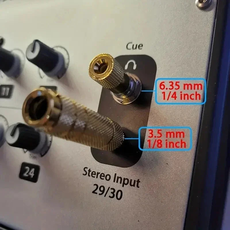 6.35 mm and 3.5 mm audio adapters beside mixer inputs