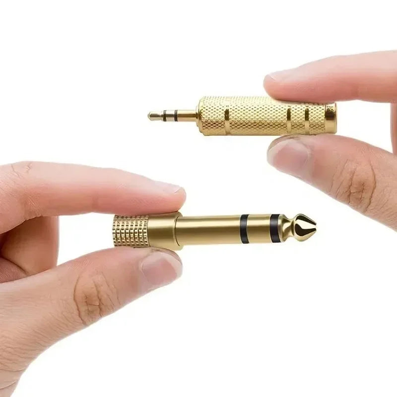3.5 mm and 6.35 mm two-piece audio adapter set held in hands